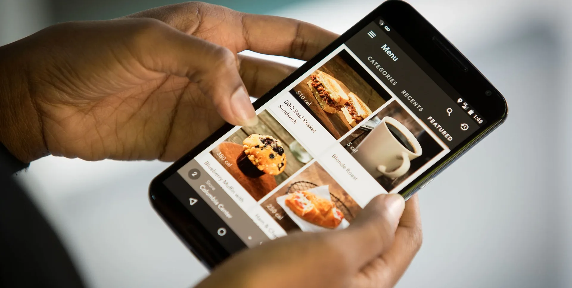 Customer ordering food on mobile phone from restaurant online ordering website